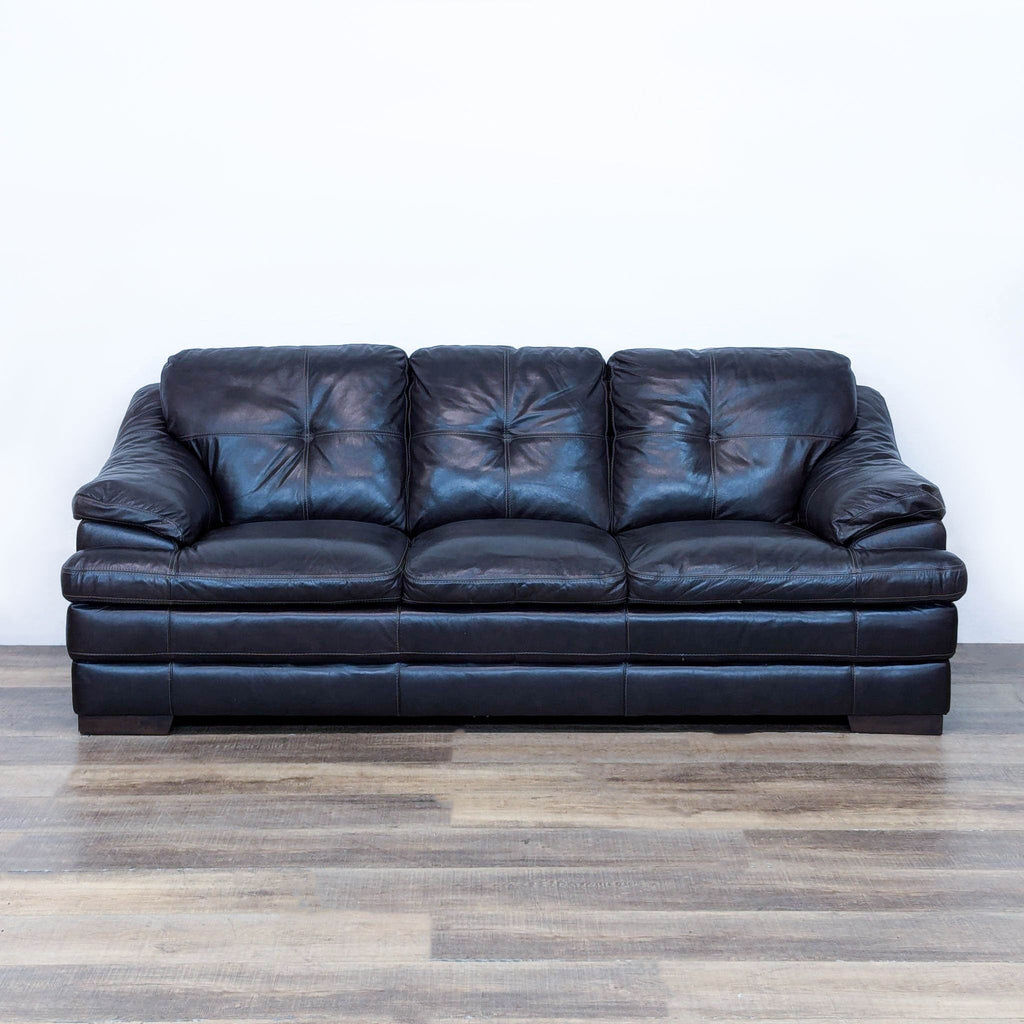 Dark brown 3-seat sofa with plush cushions, sloped arms, and button-tufted back by Reperch.