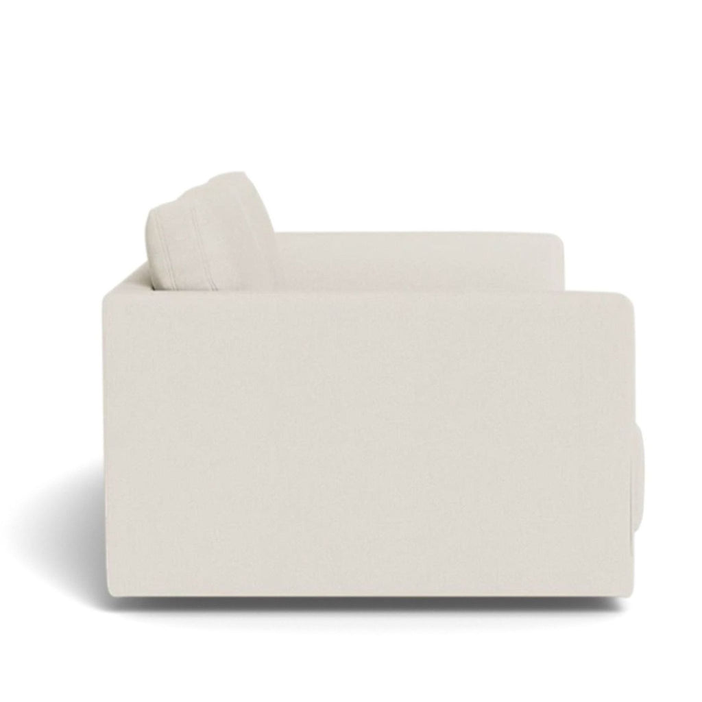 Side view of the Lukas loveseat, showcasing its sleek, floor-length frame.