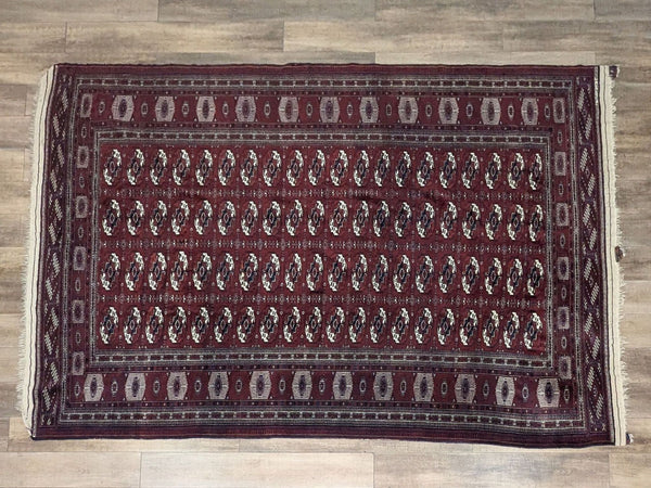 Late 20th century Turkmen Afghan rug with geometric Bukhara design and fringe.