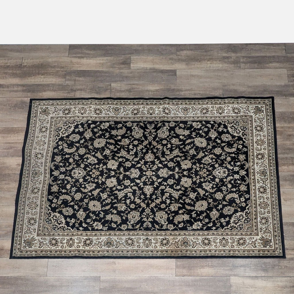 Floral wool area rug in Kashan Black by Florence Carpet, on a wooden floor.