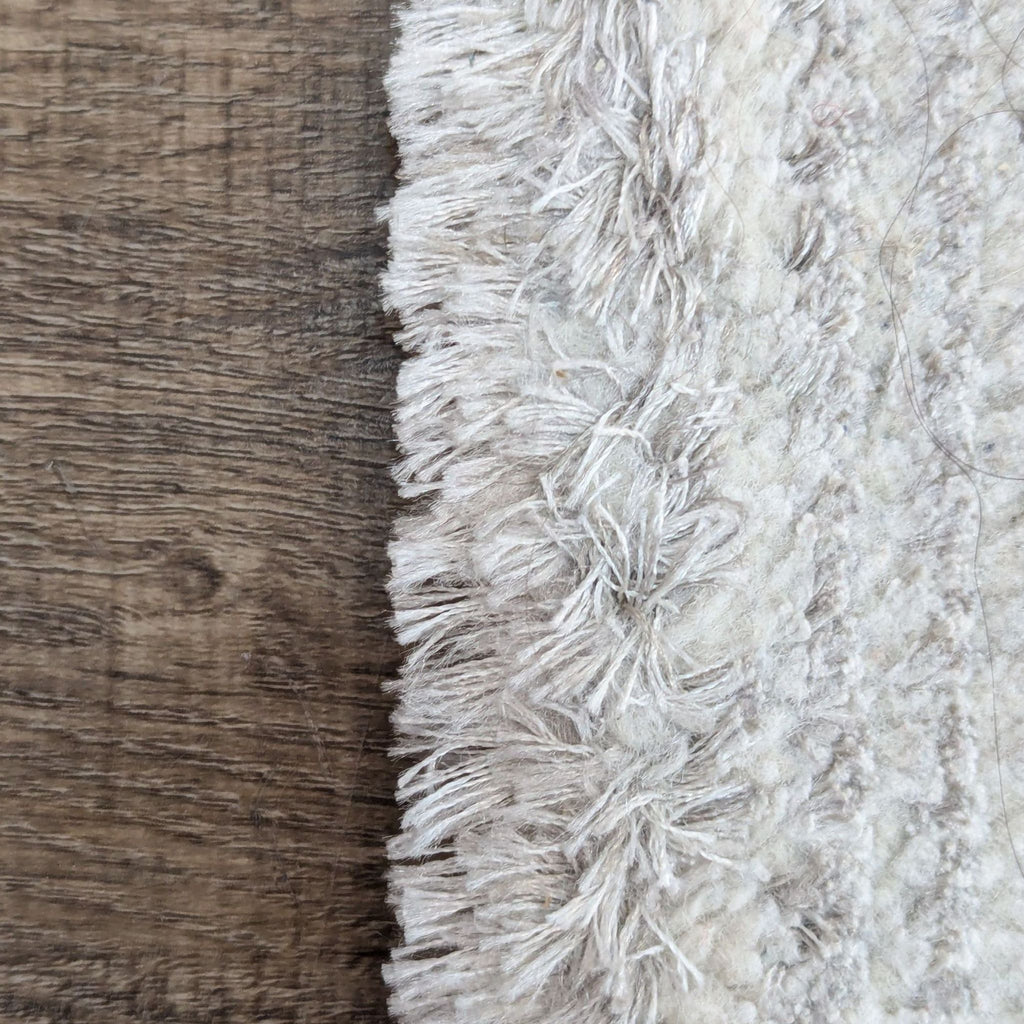 Close-up of Perla rug's textured edge detail.