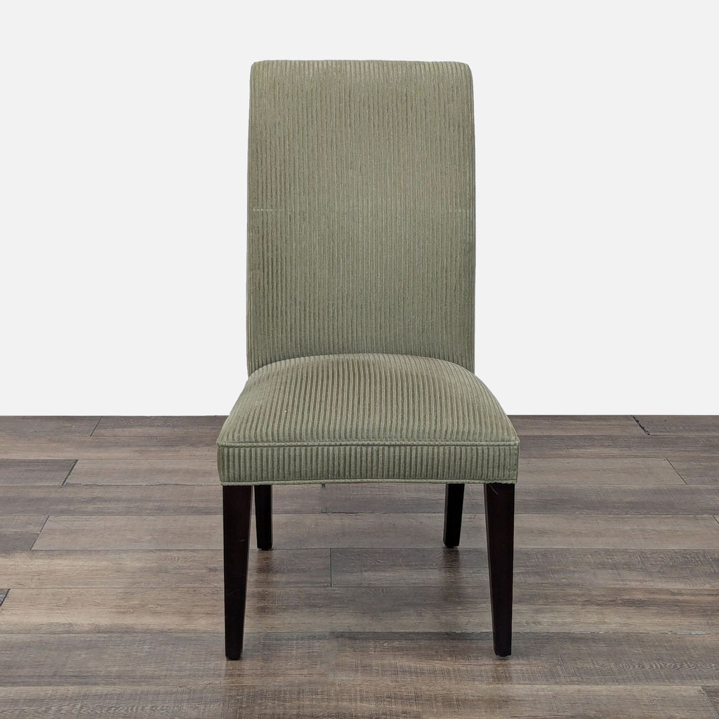 Restoration Hardware dining chair with green upholstery and dark legs, front view.