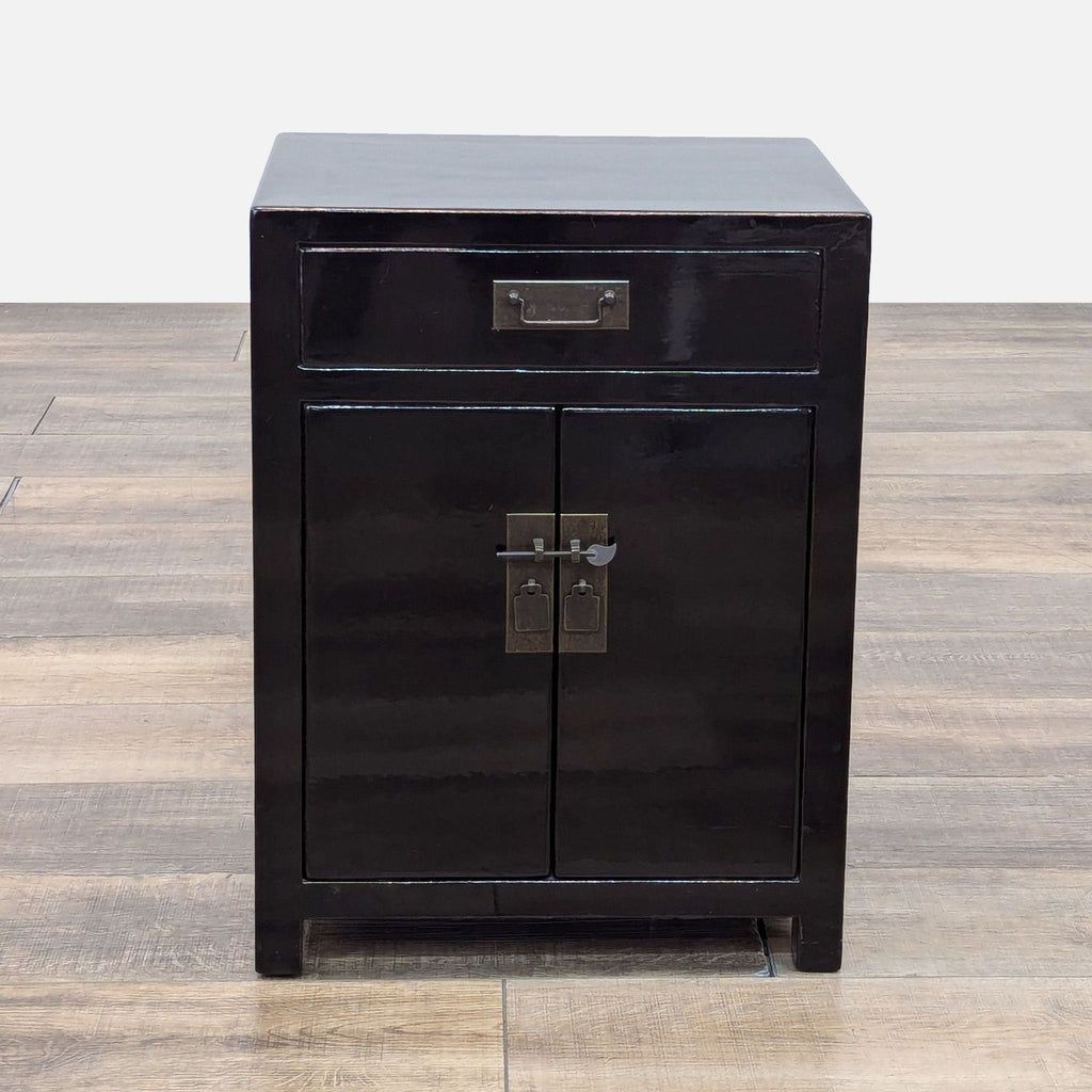 Black wood nightstand with metal hardware and lock pin, by Reperch.