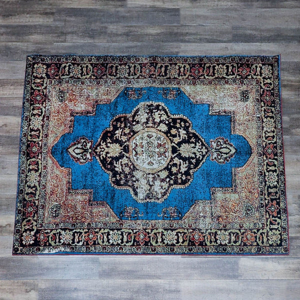 Safavieh vintage rug with intricate patterns on a blue background.