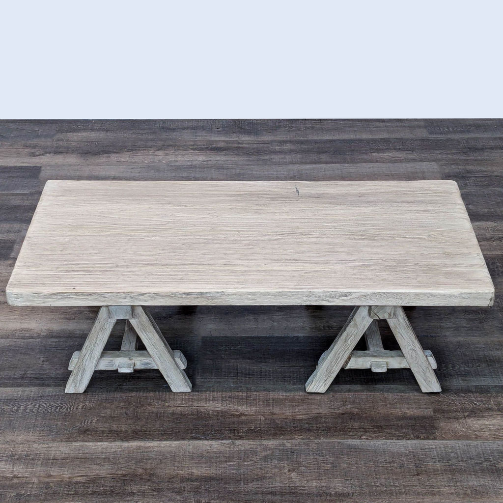 Aerial view of a Restoration Hardware coffee table with a light wood finish.