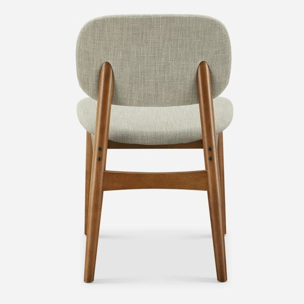 Back view of a Castlery dining chair, showing rubberwood legs and fabric seat.