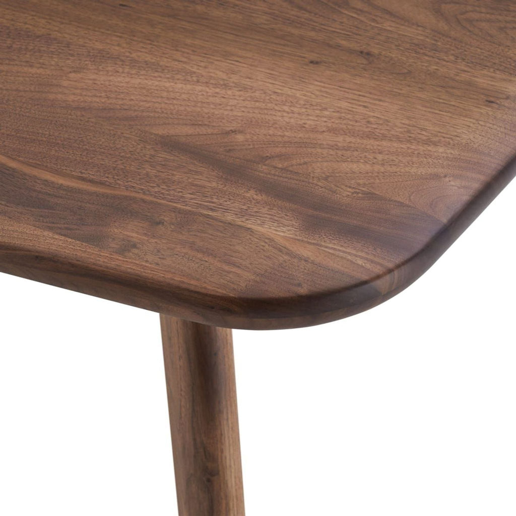 Close-up of the Castlery dining table, highlighting the rich texture of solid American walnut.