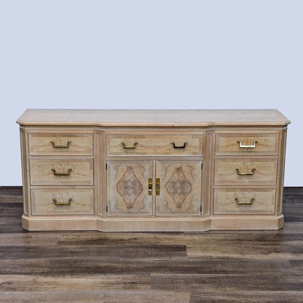 Light wood Drexel Heritage dresser with nine drawers, brass handles, and center cabinet for storage.