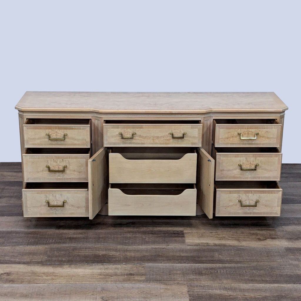 Olive burl wood dresser with open drawers showing ample storage, accented with elegant brass handles.