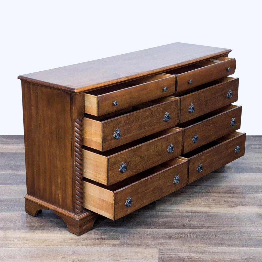 Wooden dresser featuring drop ring pulls and elegant detailing.