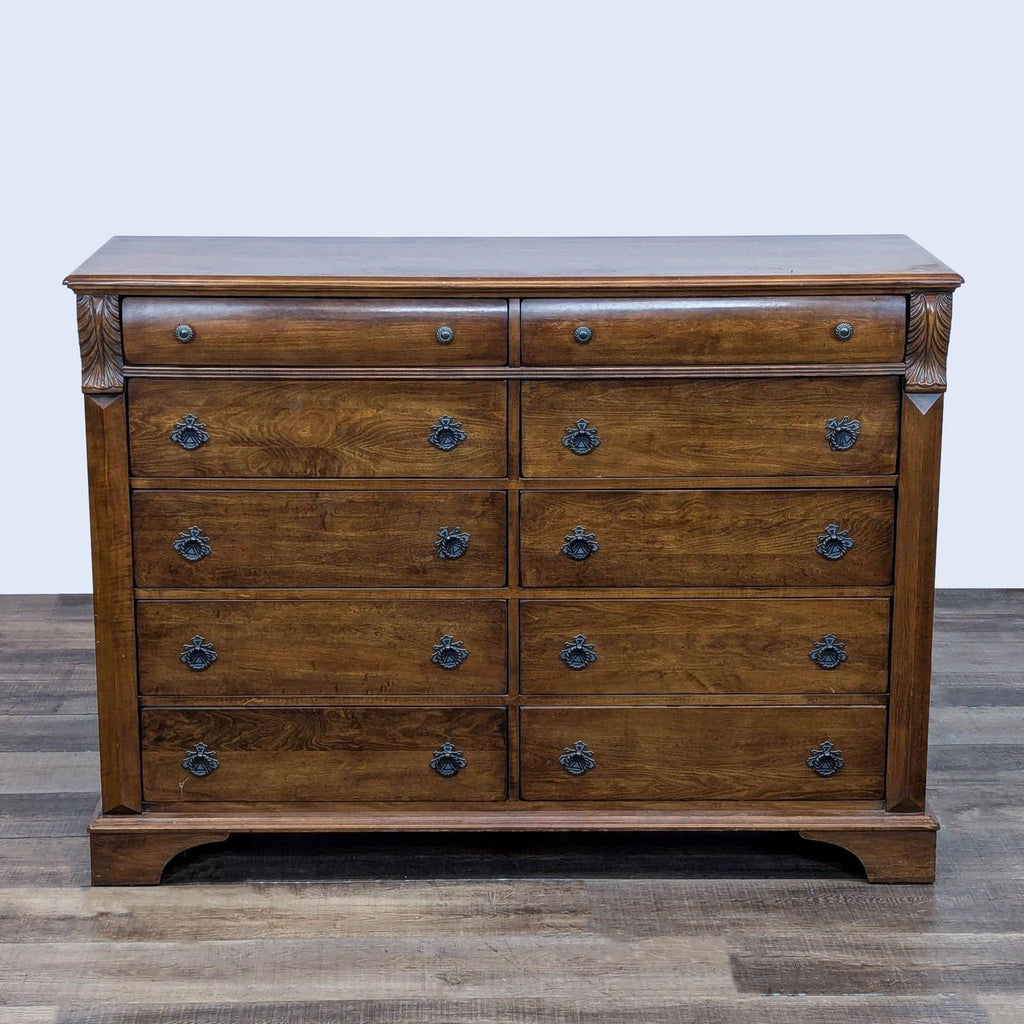 Wooden dresser with 10 drawers and drop ring pulls, featuring dovetail joinery.
