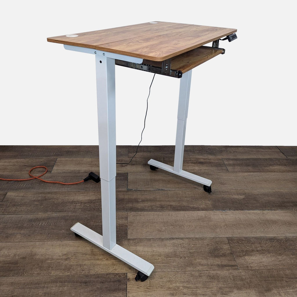 Height-adjustable desk with keyboard drawer, cord management, and lockable wheels.