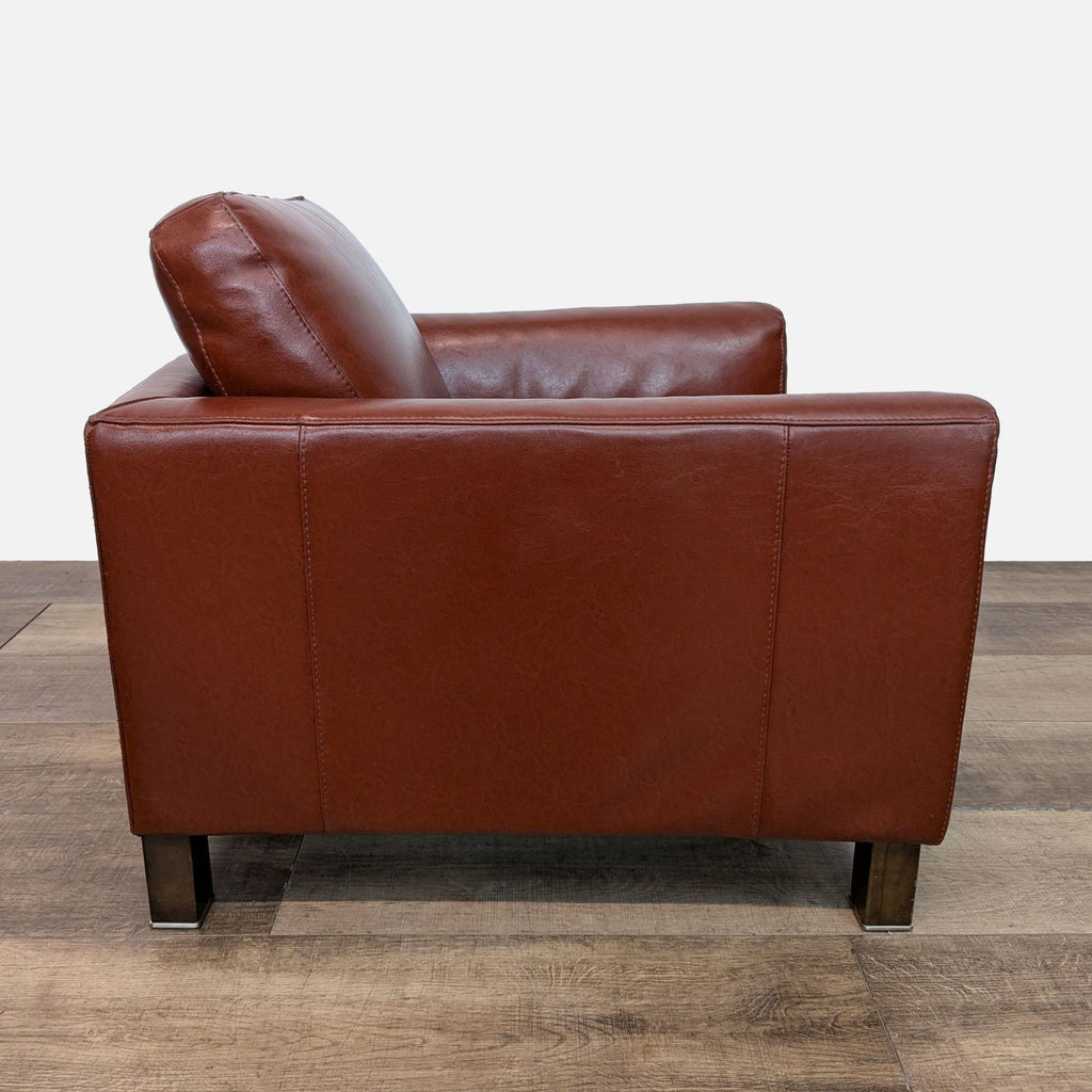 Side view of Natuzzi leather club chair, showcasing armrest.