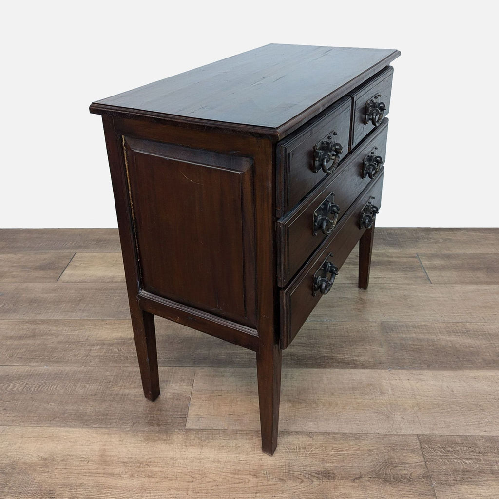 Side view of Reperch dresser showing tall legs and dark finish. 