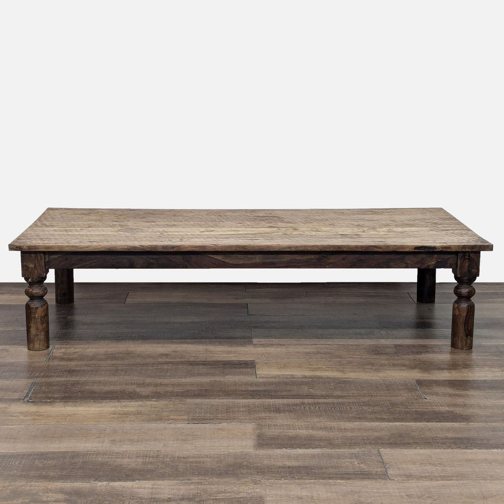 Reperch coffee table with a rustic plank top and turned legs.