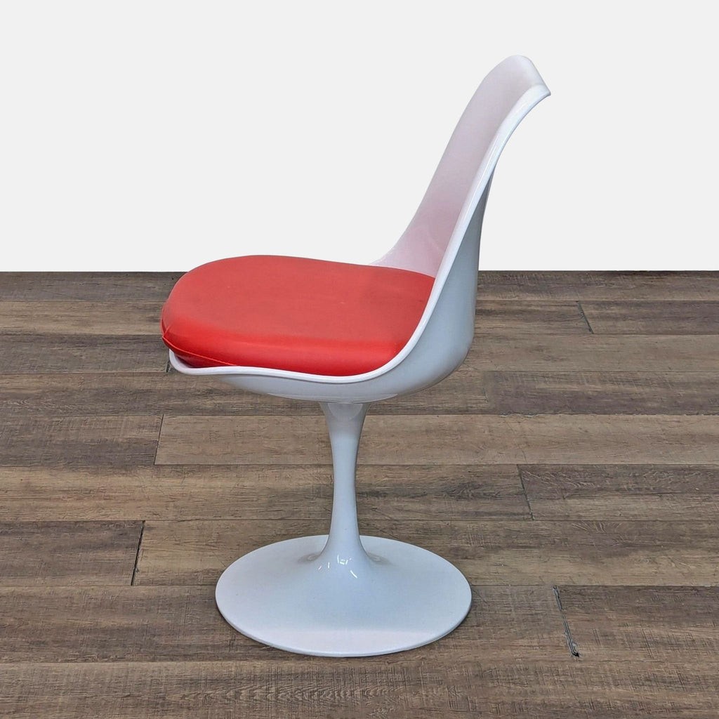 Side view of white Mid-Century chair with red seat cushion.