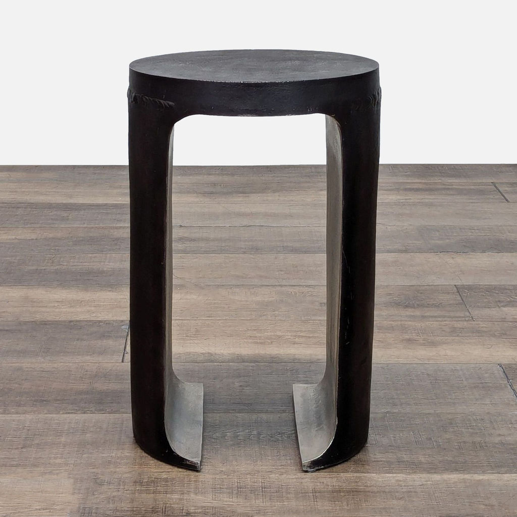 Modern black end table by Reperch, featuring a unique open design with a sturdy round top.