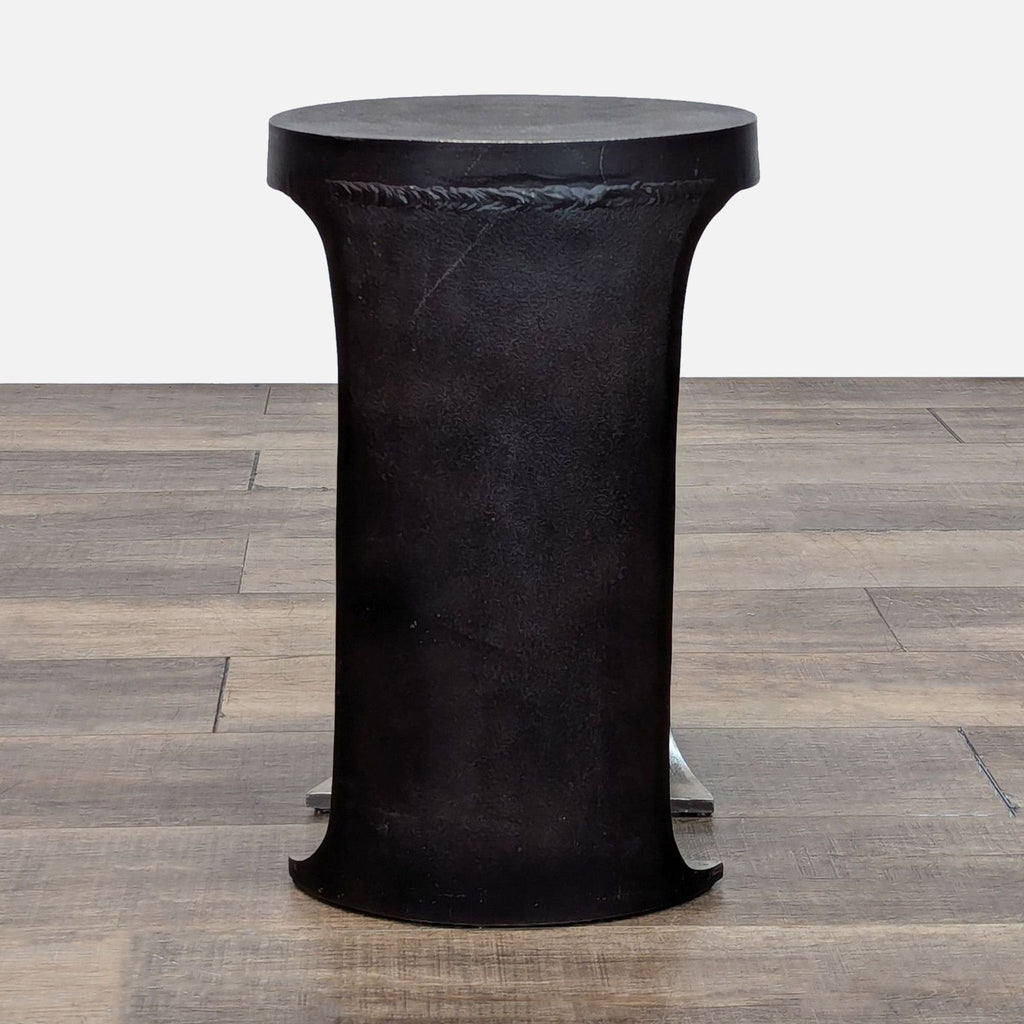 Sleek black Reperch end table with a cylindrical base, ideal for contemporary interiors.