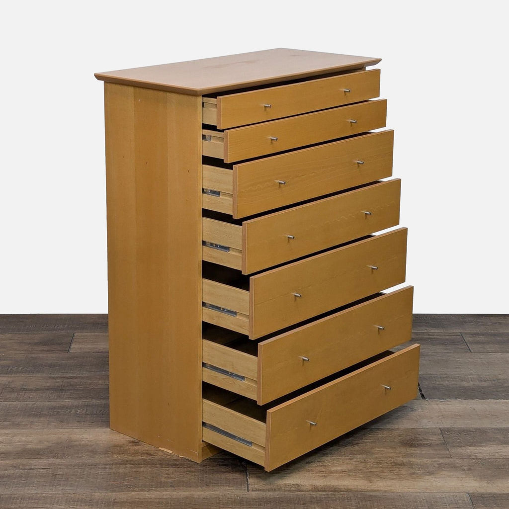 Side view of wooden dresser showing seven open drawers on metal glides.