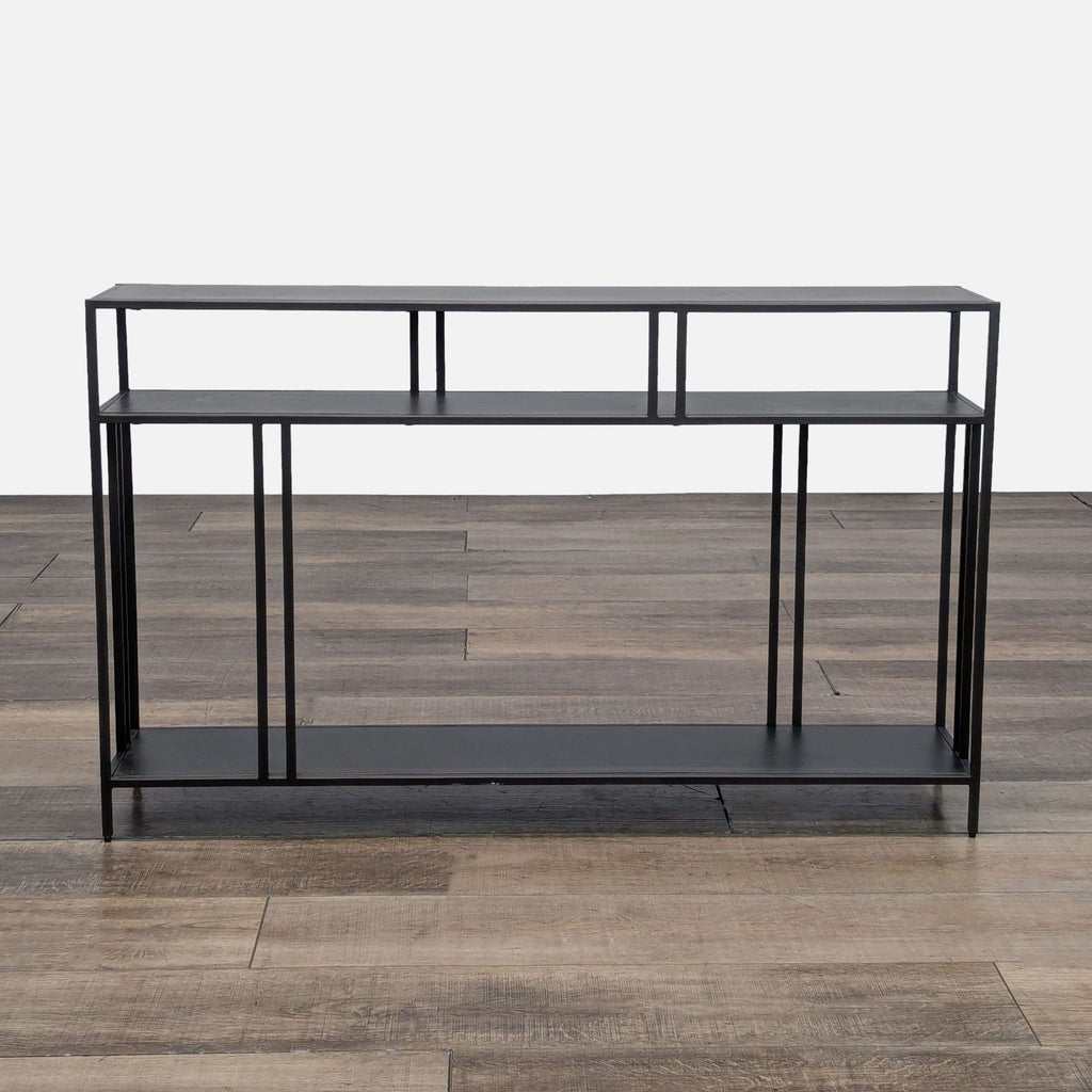 Sleek black console table with three tiers and minimalist design.