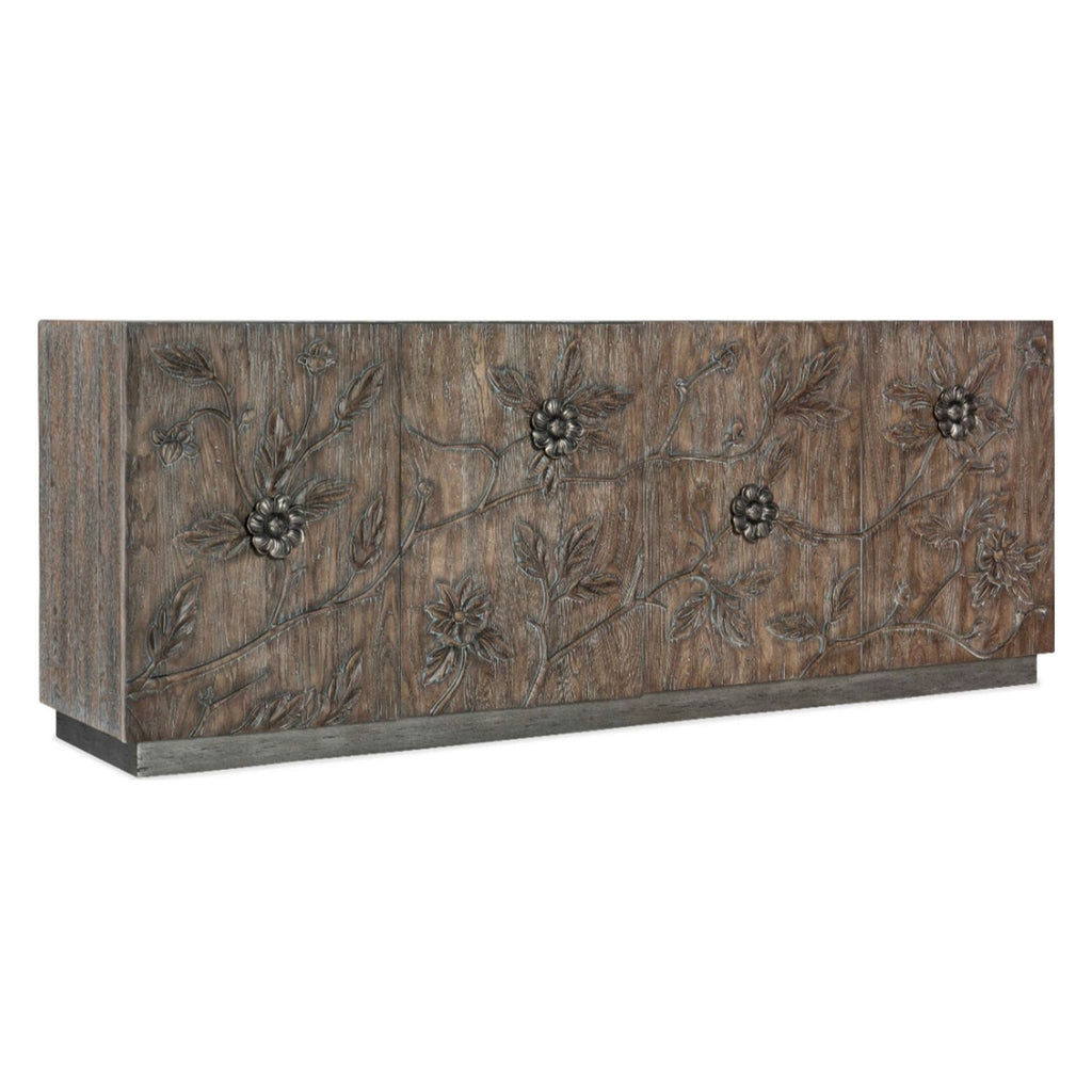 Four-door credenza with floral motifs and silver hardware, medium wood finish.