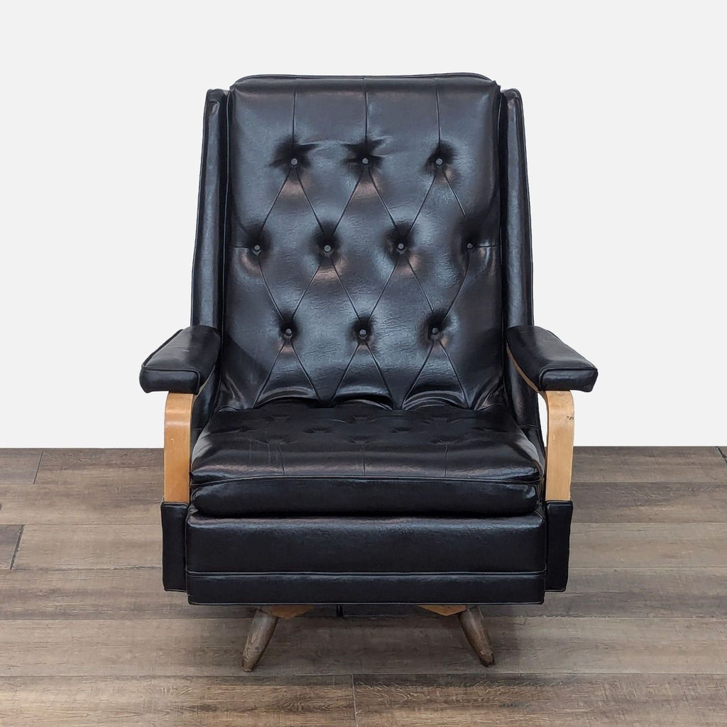 Front view of a Reperch black leather tufted lounge chair with wooden arms and legs.  