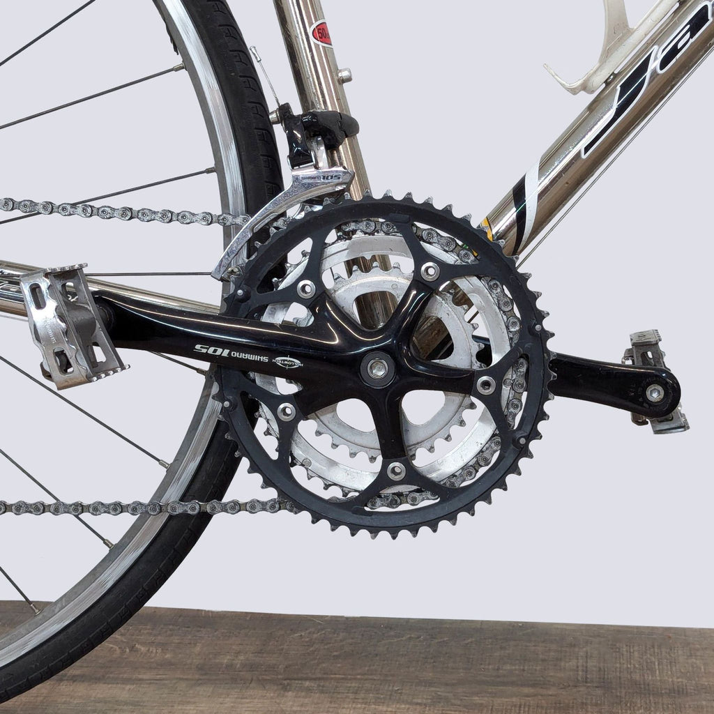 Close-up of Jamis Road Bike's precision crankset and pedal system.
