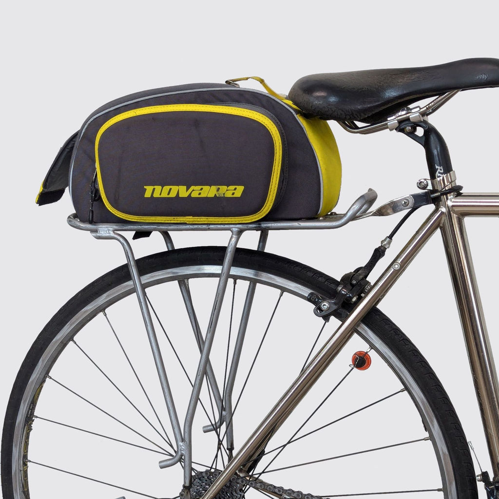Rear view of bike with Novara storage bag attached above the wheel.