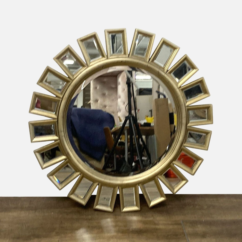Round mirror with antiqued frame, sunburst design by Reperch, featuring mirror insets.
