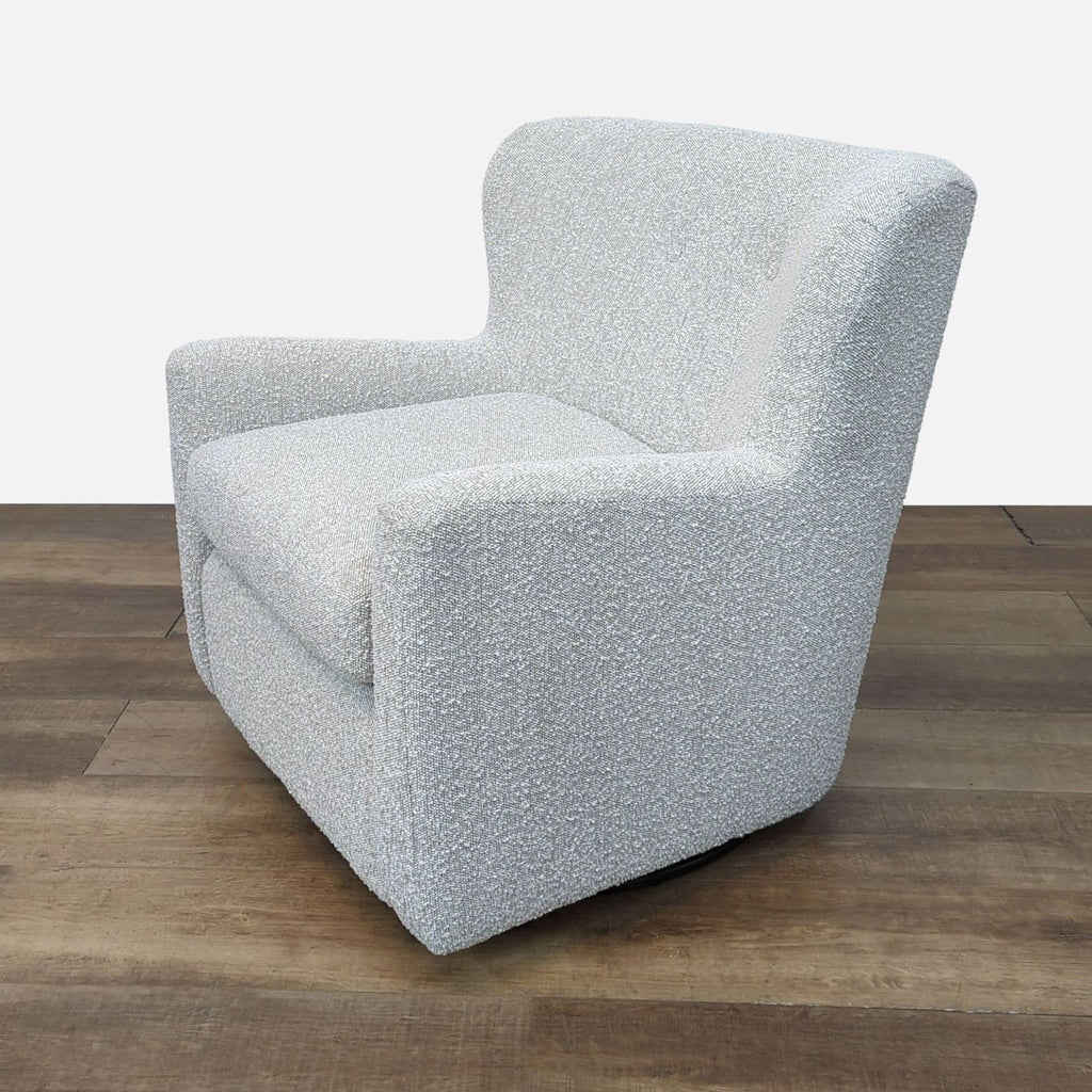 Side angle of the wingback-inspired Jollette chair on a swivel base.