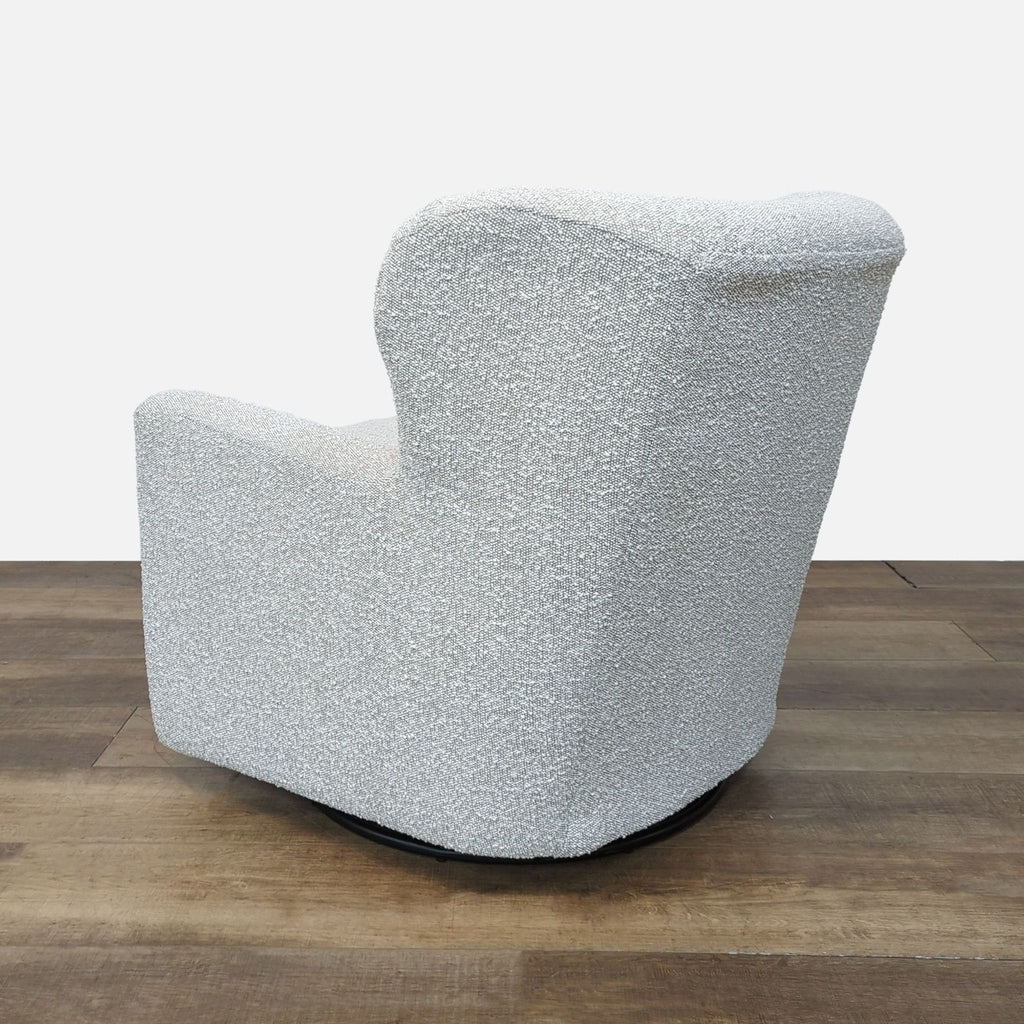Back view of the Jollette chair, showcasing its curved silhouette and textured fabric.