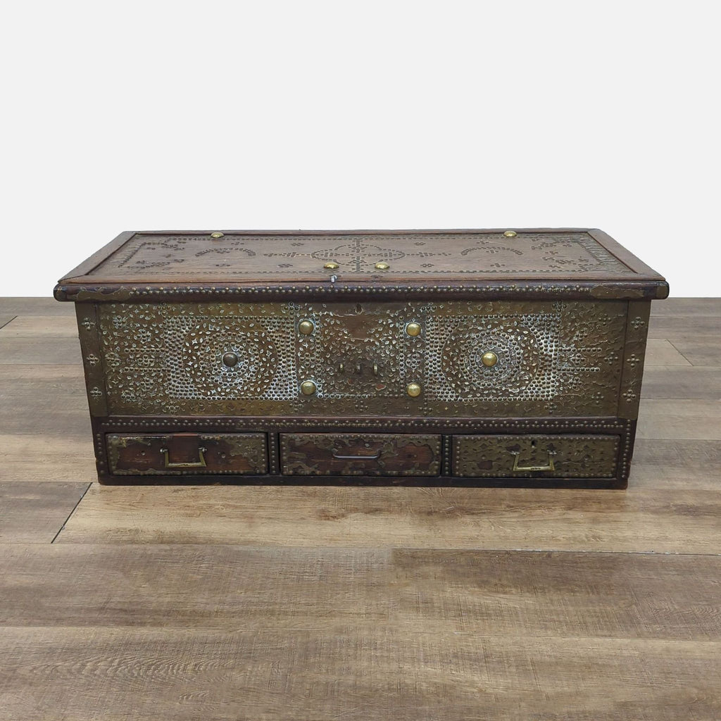 Zanzibar trunk with ornate brass designs, representing a cultural fusion of art from various regions.