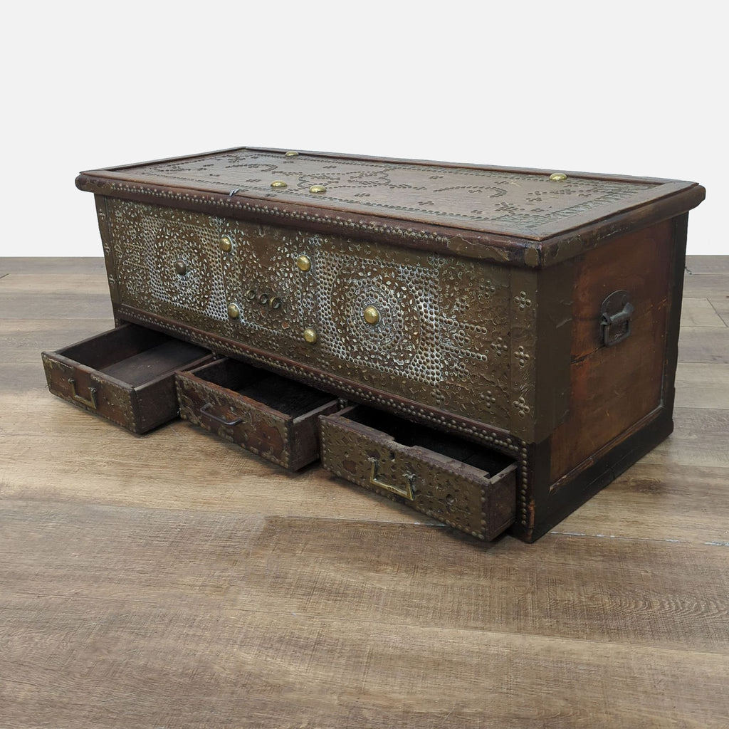 Side view of the trunk with drawers open, showcasing its elaborate design and storage capacity.