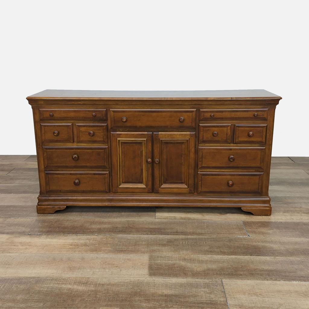 Traditional triple dresser by Alexander Julian, crafted from cherry wood with multiple drawers.