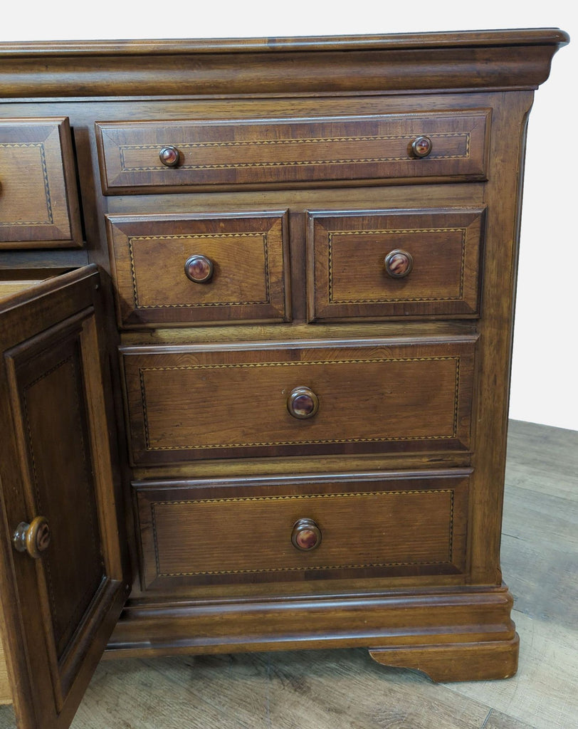 Close-up of cherry wood dresser drawers, highlighting craftsmanship and detail in Alexander Julian design.