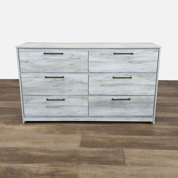 Dresser with six drawers, engineered wood, linear metal pulls, by Ashley Furniture.