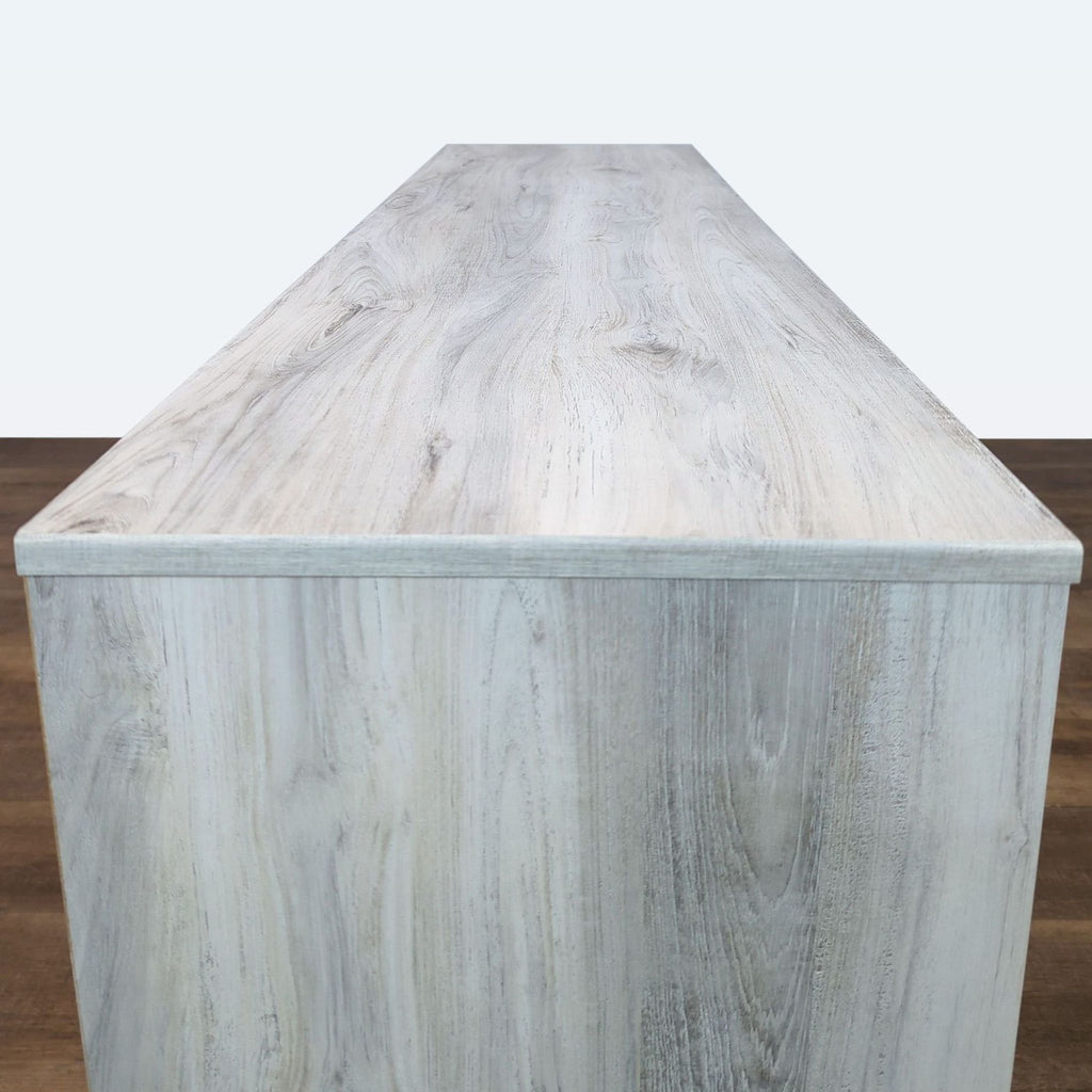 Top view of wood-grain dresser by Ashley Furniture, showcasing veneer texture.