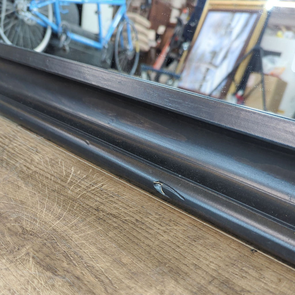 Close-up of the mirror's base showing a small chip on the frame.