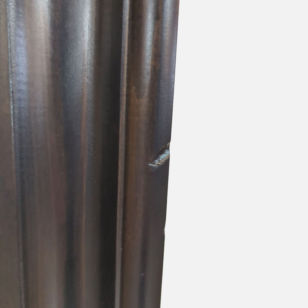 Detailed view of a scratch on the mirror's side frame.