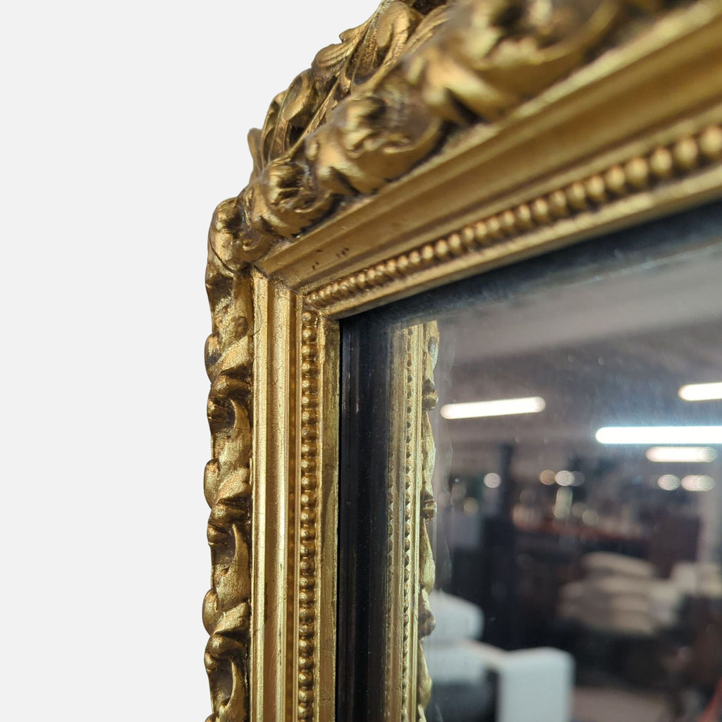 Detailed view of the Reperch mirror's elegant gold frame, highlighting its decorative patterns.