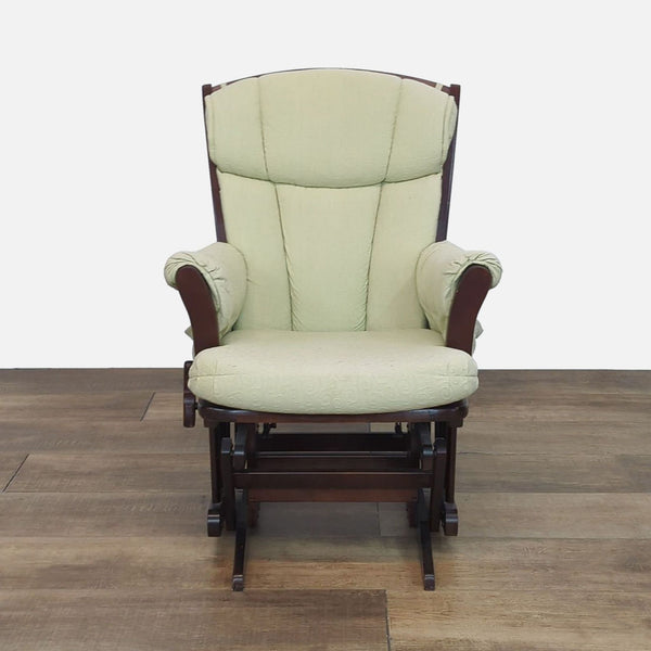 Front view of a classic wood frame glider chair with green cushions.