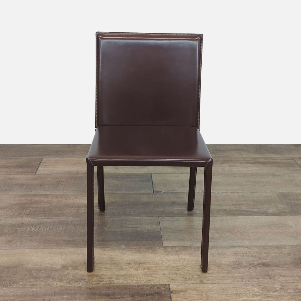 Front view of a Reperch chair fully covered in brown leather with visible overall stitching details.