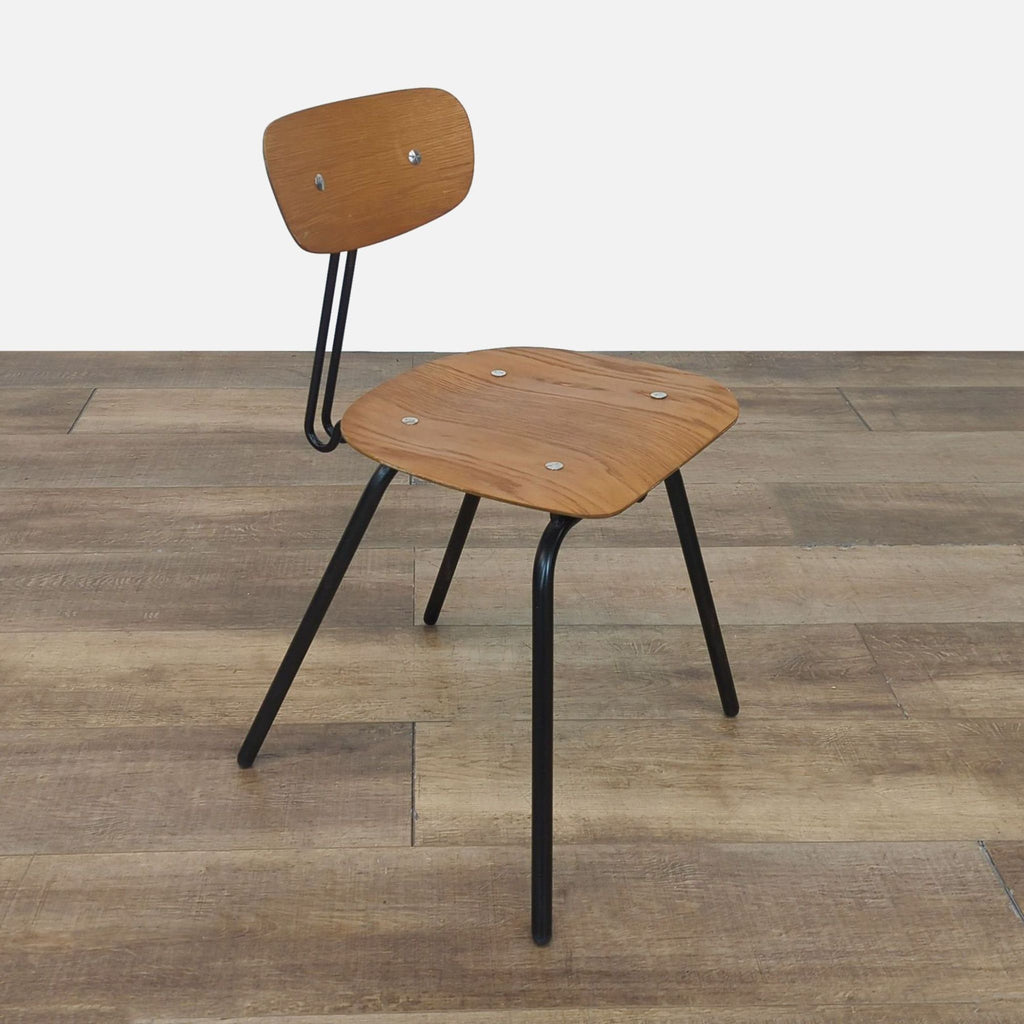 Side angle of the Eames style Wooden Student Chair on a wooden floor.