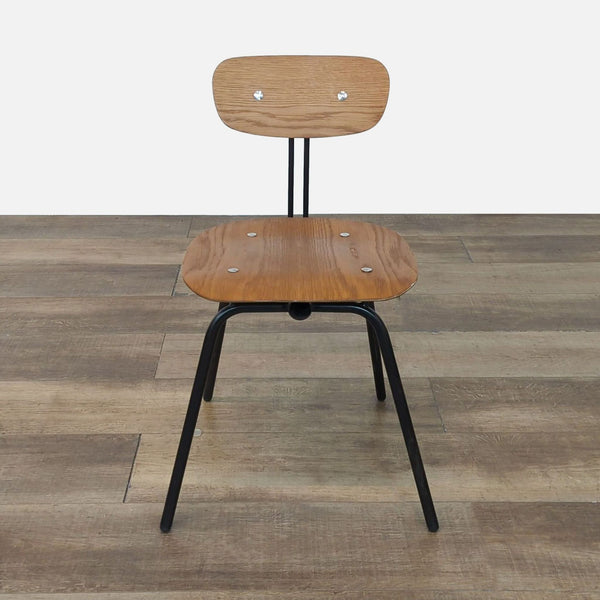 Front view of the Eames style Wooden Student Chair on a wooden floor.