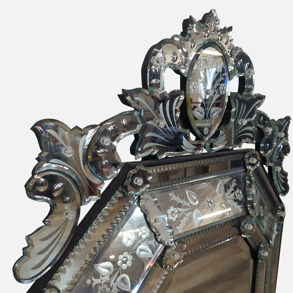 Close-up of Reperch mirror's ornate top, featuring floral motifs and intricate carvings.