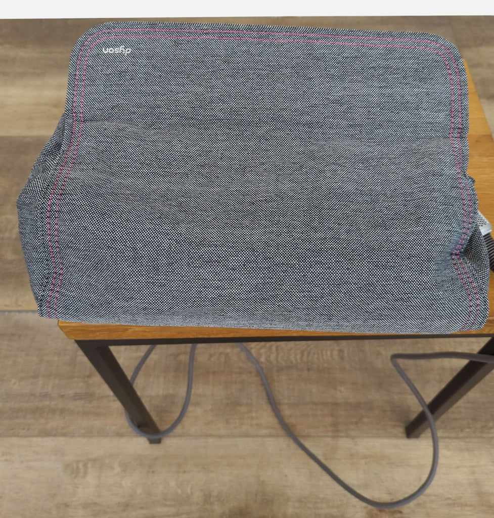 Storage bag for Dyson hairdryer, featuring a textured fabric with stitching.