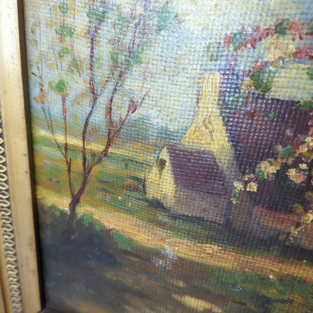Close-up of textured brushwork, depicting a countryside scene in an ornate gold frame.