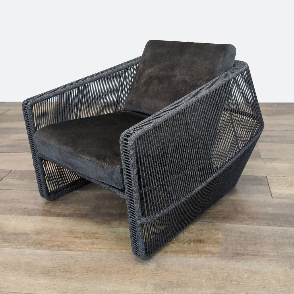 Holly Hunt Scarab outdoor lounge chair with suspended quick-dry seat and handwoven geometric black frame.  