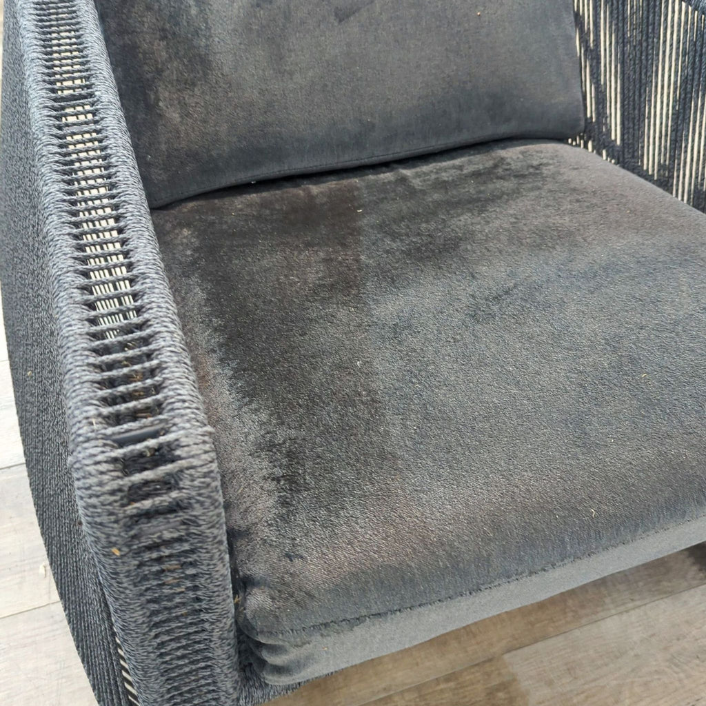 Close-up of the Scarab chair’s plush quick-dry black seat cushion and handwoven side frame detail.  