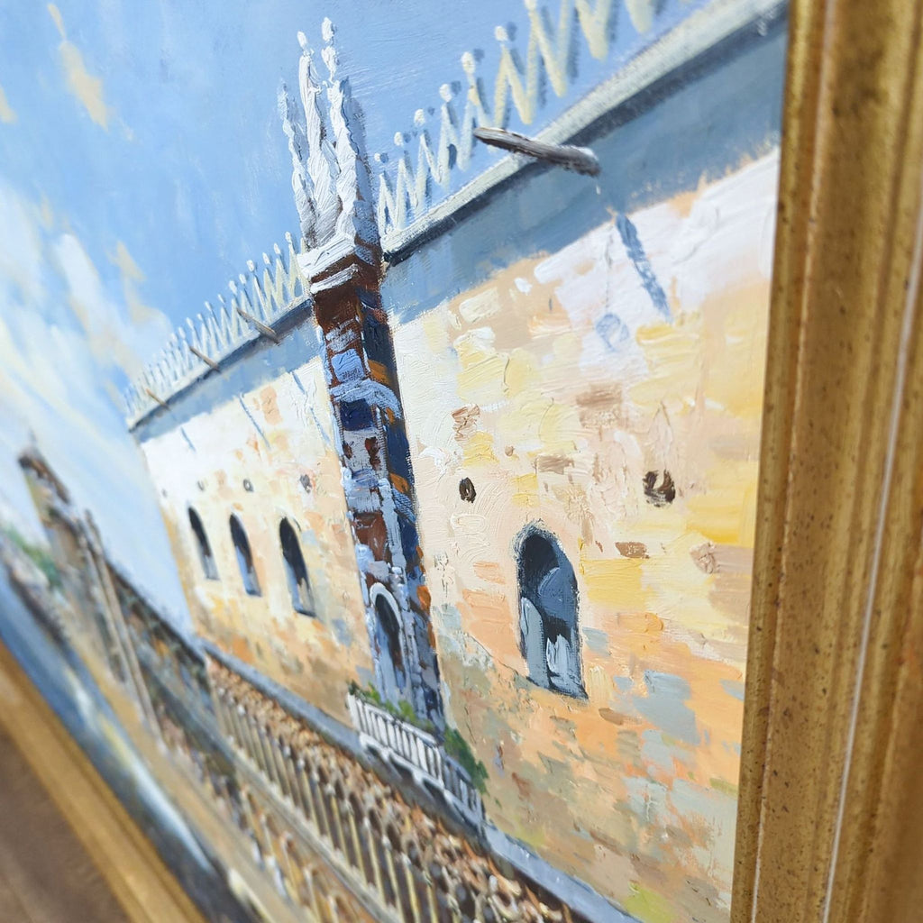 Close-up of oil painting texture depicting Venice waterfront, framed in gilded gold.